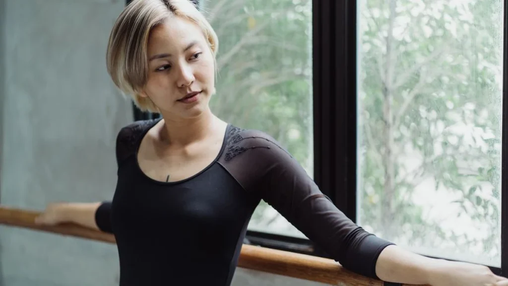 What is barre: a woman at a ballet barre in a boutique Henderson studio